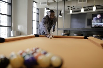 Male Holding Cue Stick Ready to Hit the Ball