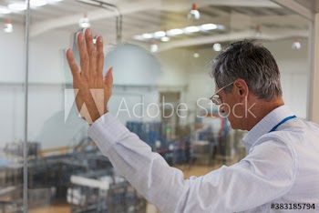 Male manager supervising factory floor