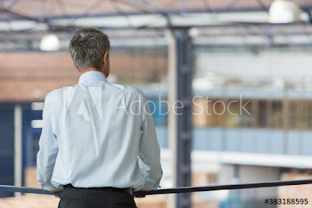Male manager supervising factory floor