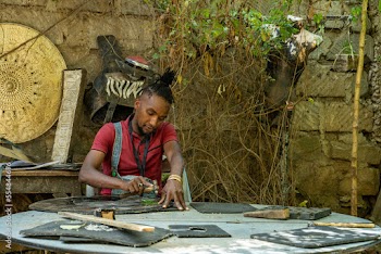 male metal artist using a hammer