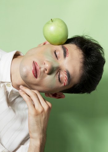 Male model posing with apple Free Photo