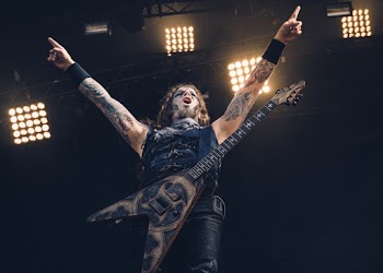 Male Performer With Guitar on Stage