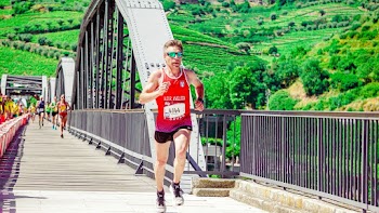 Male Runner Running on a Concrete Bridge