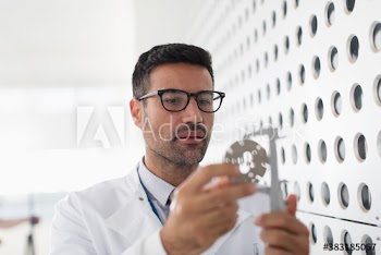 Male scientist using calipers