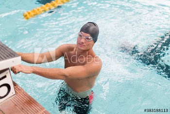 Male swimmer preparing in swimming pool