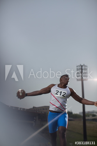Male track and field athlete throwing discus