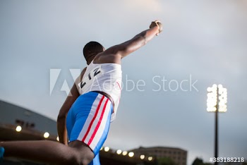 Male track and field athlete throwing shot put