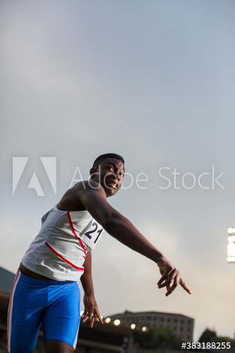 Male track and field athlete throwing shot put