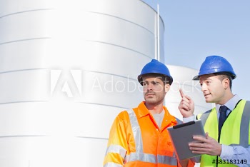 Male worker and manager with digital tablet talking