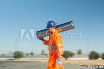 Male worker carrying stainless steel tank