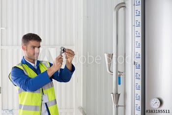 Male worker with calipers examining equipment in factory