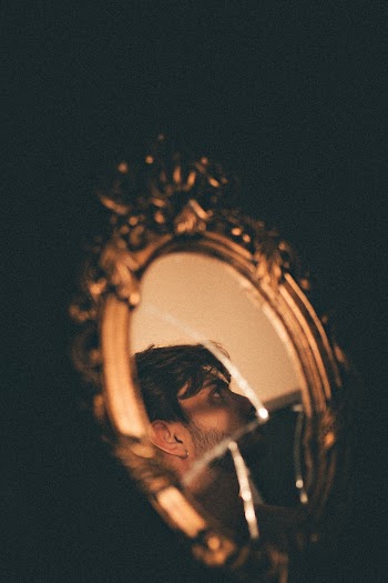 Man's Face Reflecting on Mirror