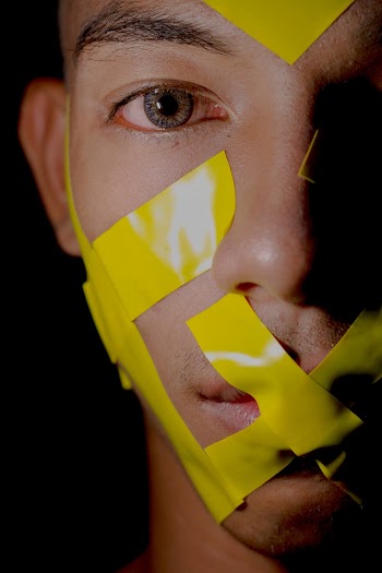 Man's Face With Yellow Adhesive Tapes
