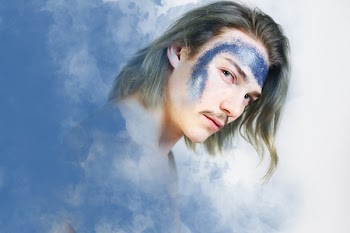 Man's Portrait Photo Against Clouds As Background