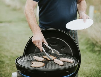 Man About to Pick Grilled Meat