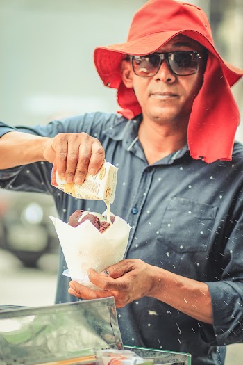Man About to Pour White Liquid on White Bowl