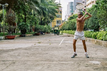 Man About to Strike Using Tennis Racket