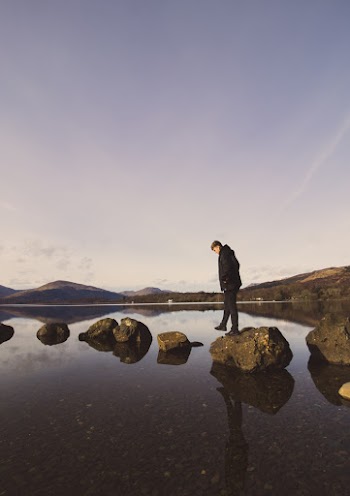 Man About to Walk on Rocks by the Body of Water