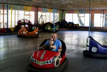 Man and Boy Riding Bumper Car