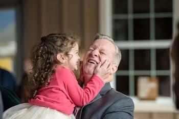 Man And Girl Smiling Shallow Focus Photography