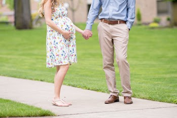 Man And Pregnant Woman Holding Hands