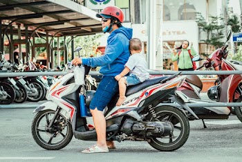 Man And Toddler Riding On Motorcycle