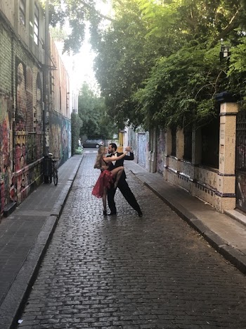 Man and Woman Dancing in Middle of Alleyway