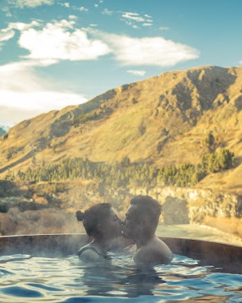 Man and Woman Dipped in Swimming Pool While Kissing