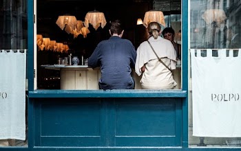 man and woman eating inside restaurant