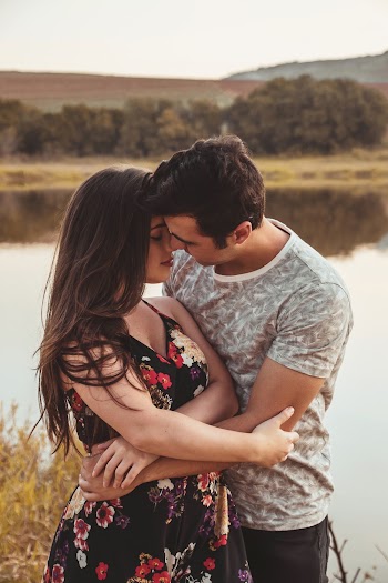 Man and Woman Facing Each Other While Hugging Near River