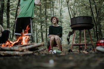 Man and Woman Gathering Around a Bonfire