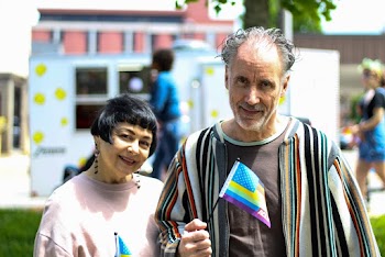 Man and Woman Having Twofie Picture Holding Up Flaglets
