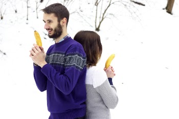 Man and Woman Holding Banana