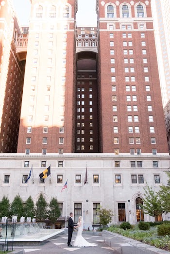 Man And Woman Holding Hands Near White And Brown Building