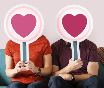 Man and Woman Holding Heart Boards