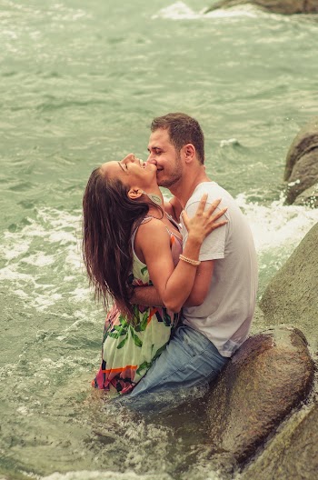 Man and Woman Hugging Each Other While Dipped in the Sea