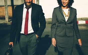 man and woman in formal suit standing beside each other