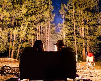 man and woman in front of campfire