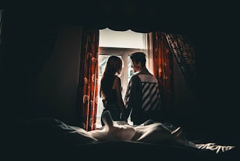 Man and Woman in Front of Window