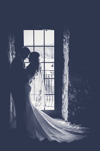 man and woman in wedding attire holding each other