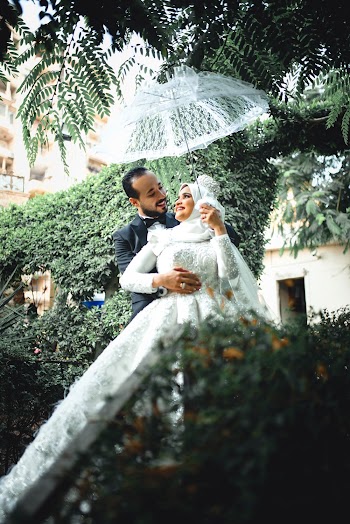 Man and Woman In Wedding Attire Posing For A Photo Shoot
