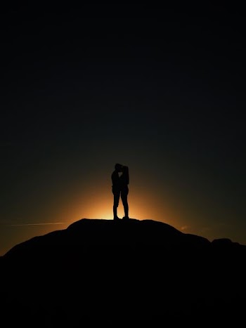 man and woman kissing