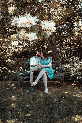 Man and woman kissing while sitting on a bench