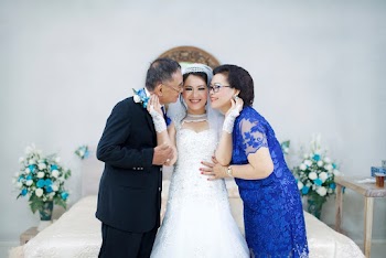 Man and Woman Kissing Woman in White Wedding Dress