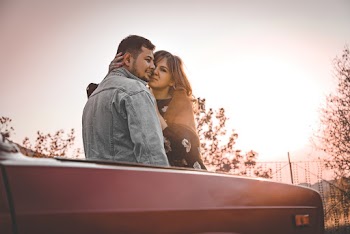 Man and Woman Leaning on Car
