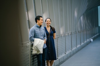Man And Woman Leaning On Hand Rail