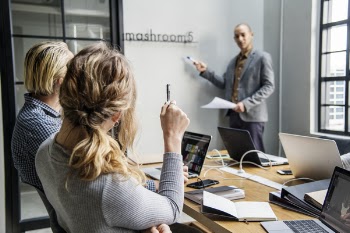 Man and Woman Looking at Man Standing Near Window