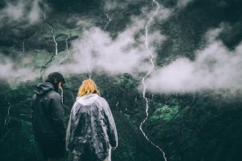 man and woman looking at mountains