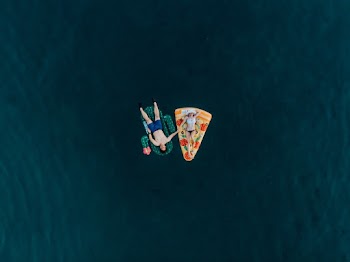 Man and Woman Lying on Inflatable Floater