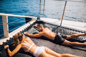 Man and Woman Lying on Trampoline